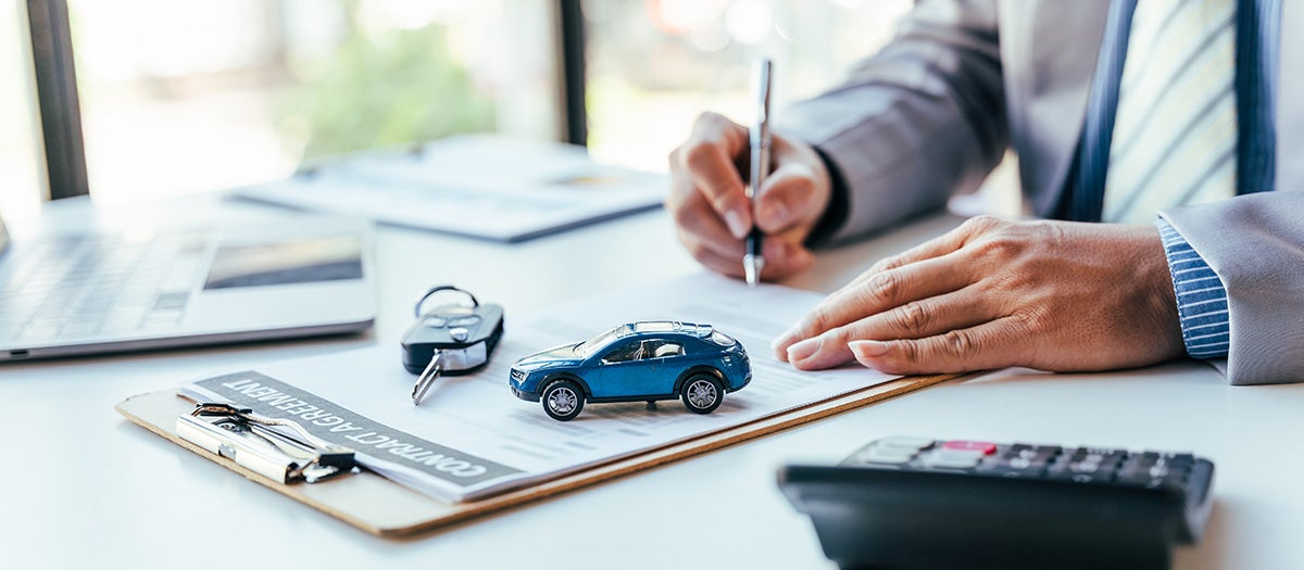 Customer reviewing vehicle purchase paperwork