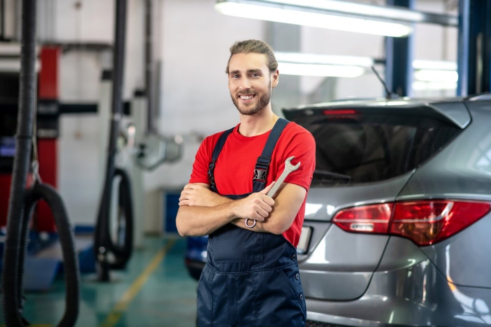 Service technician performing Kia maintenance in Auburn Washington